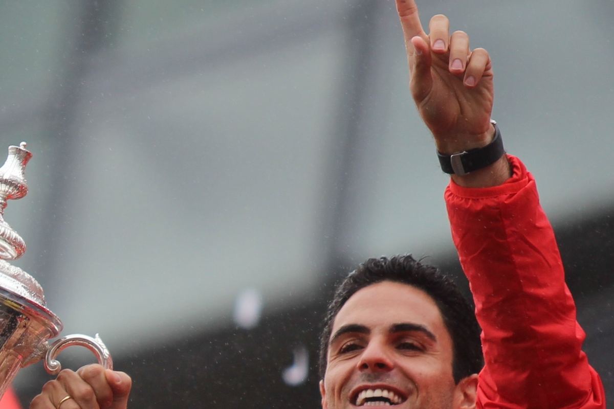 Mikel Arteta standing on the touchline in a dark training jacket during an Arsenal match.