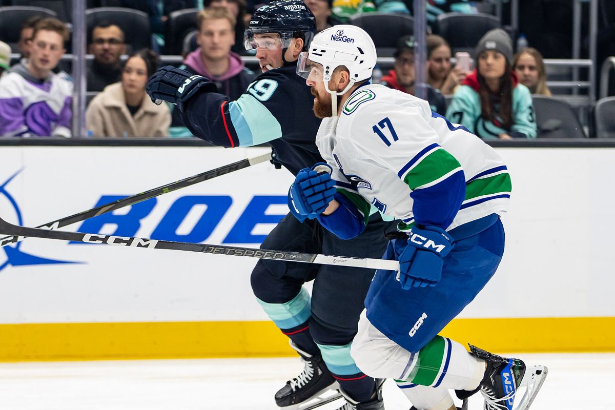 Filip Hronek of the Vancouver Canucks skating with the puck during a game.