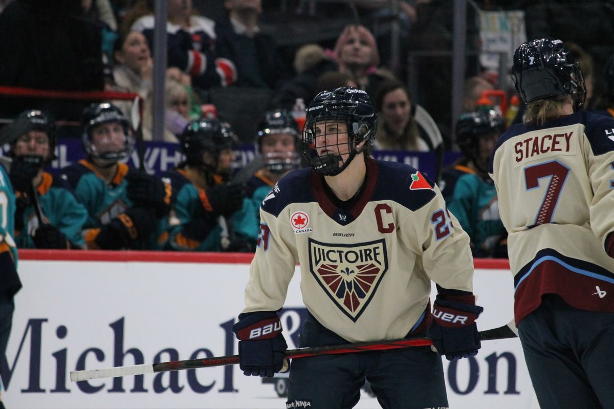 Marie-Philip Poulin in a Montreal Victoire jersey skating with the puck during a PWHL game.