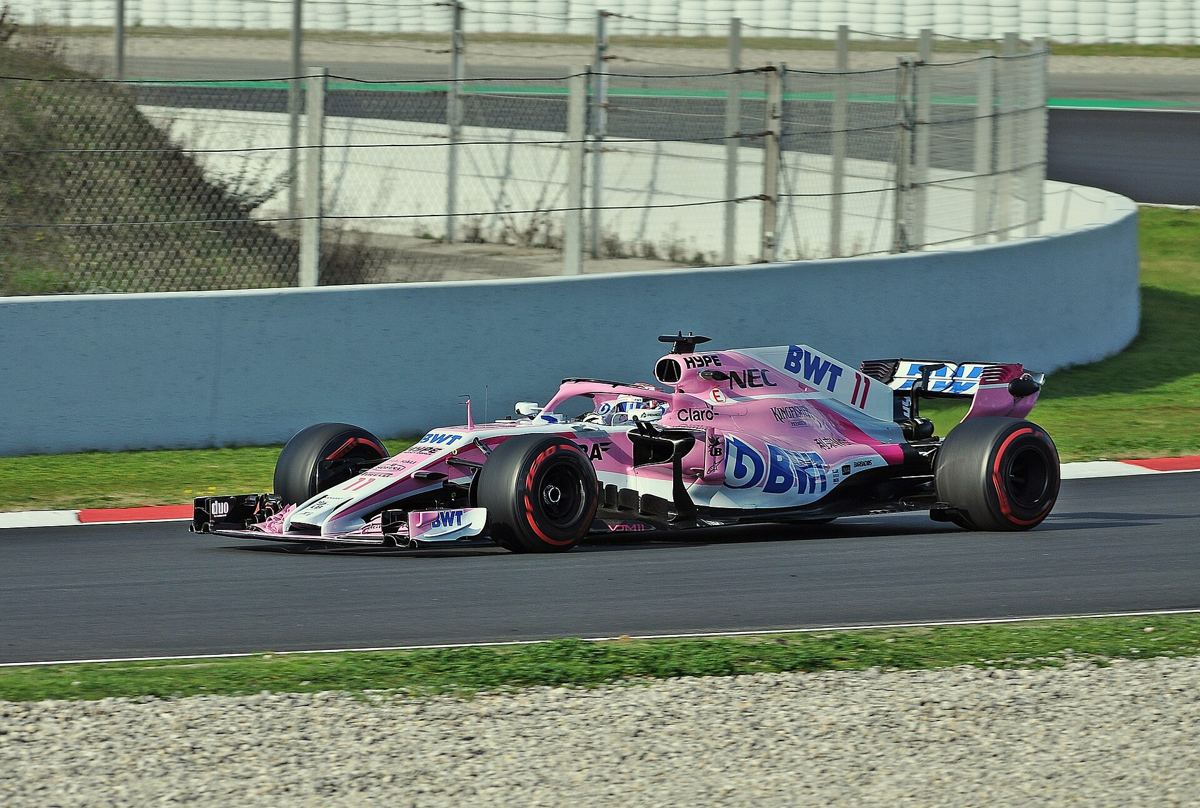 Sergio Pérez in Cadillac F1 team gear standing in the pit lane before a Grand Prix.