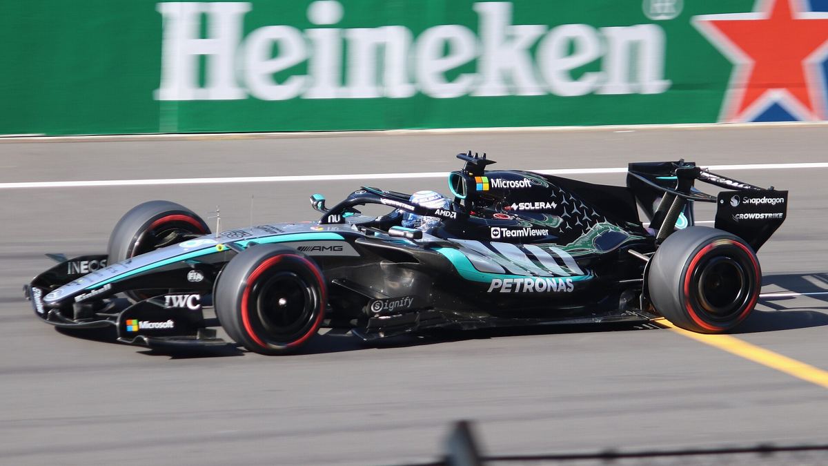 George Russell in his Mercedes race suit in the paddock.